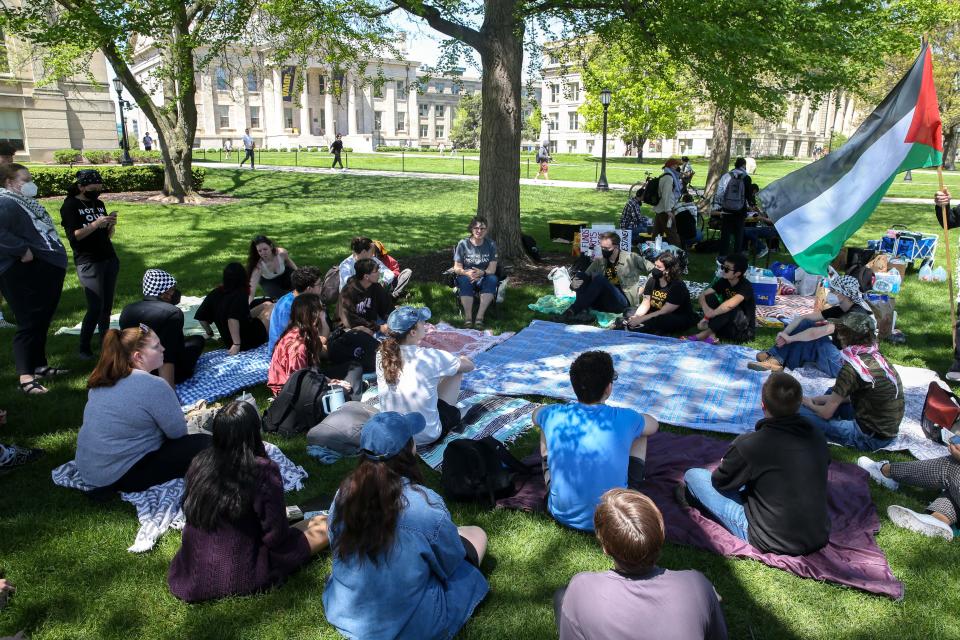 Participants of a demonstration and educational event concerning the Israel-Hamas war gather for a discussion period Friday, May 3, 2024 on the Pentacrest in Iowa City, Iowa.