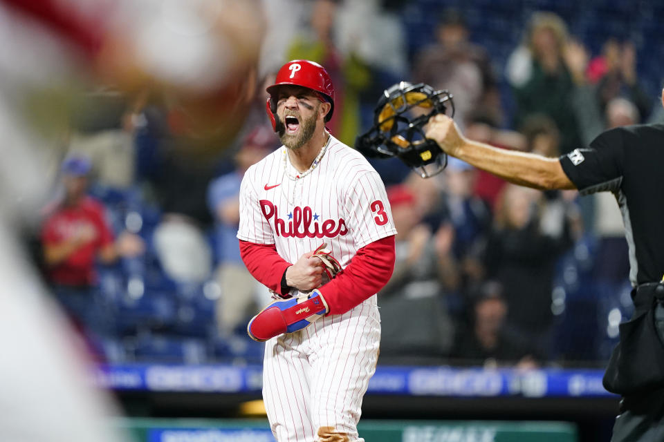 Philadelphia Phillies' Bryce Harper celebrates after scoring the game-winning run on an RBI-single by Jean Segura during the ninth inning of a baseball game, Tuesday, Sept. 6, 2022, in Philadelphia. (AP Photo/Matt Slocum)