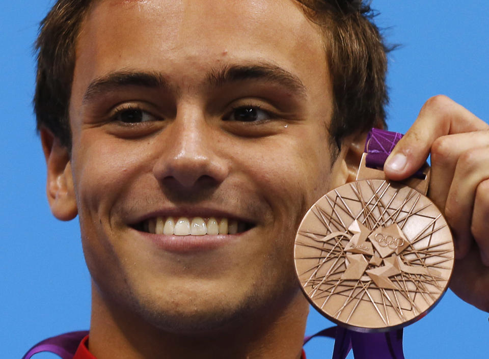 Britain's Tom Daley poses with his bronze medal during the men's 10m platform victory ceremony at the London 2012 Olympic Games at the Aquatics Centre August 11, 2012. REUTERS/Tim Wimborne (BRITAIN - Tags: SPORT DIVING OLYMPICS) 