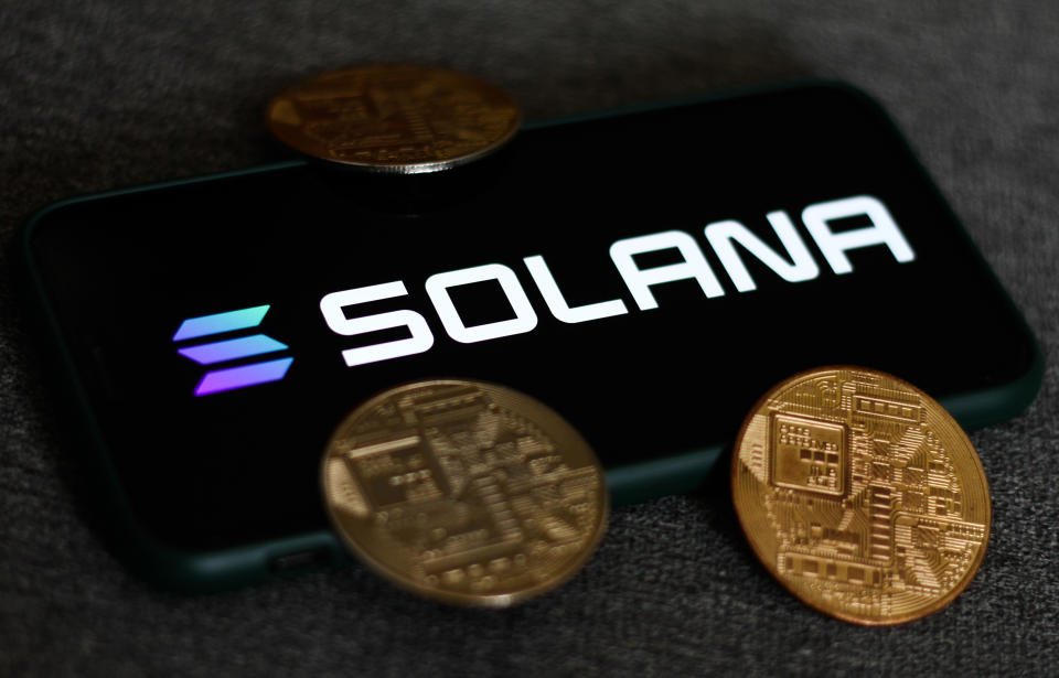 Solana logo displayed on a phone screen and representation of cryptocurrencies are seen in this illustration photo taken in Krakow, Poland on August 21, 2021. (Photo Illustration by Jakub Porzycki/NurPhoto via Getty Images)