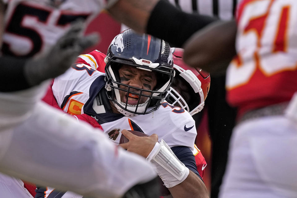 Denver Broncos quarterback Russell Wilson (3) is sacked by Kansas City Chiefs defensive tackle Khalen Saunders (99) during the second half of an NFL football game Sunday, Jan. 1, 2023, in Kansas City, Mo. (AP Photo/Charlie Riedel)