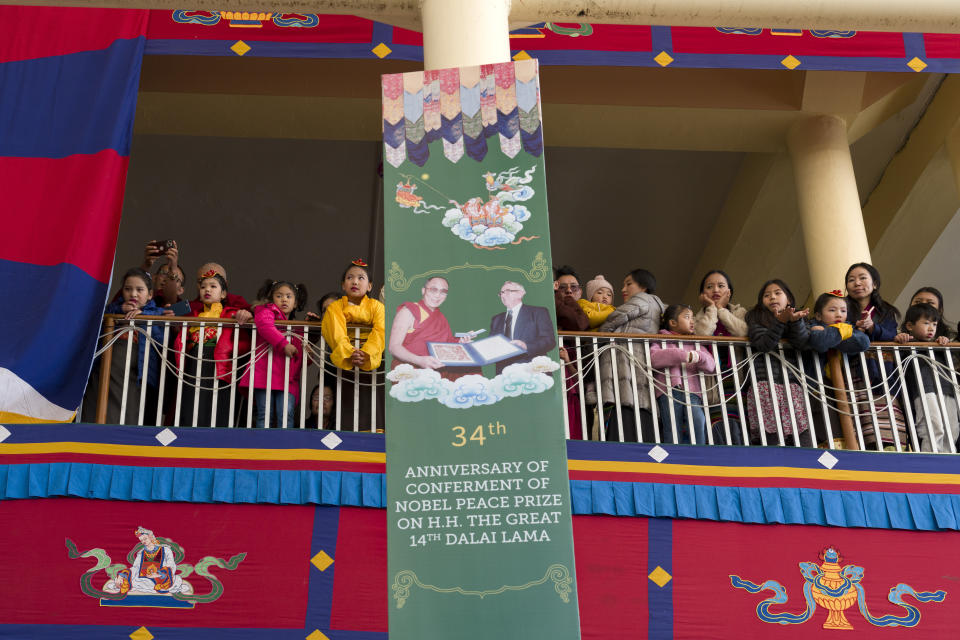 Exile Tibetans watch from the balcony during an event marking the anniversary of the awarding of the Nobel Peace Prize to the Dalai Lama in Dharamshala, India, Sunday, Dec. 10, 2023. (AP Photo/Ashwini Bhatia)