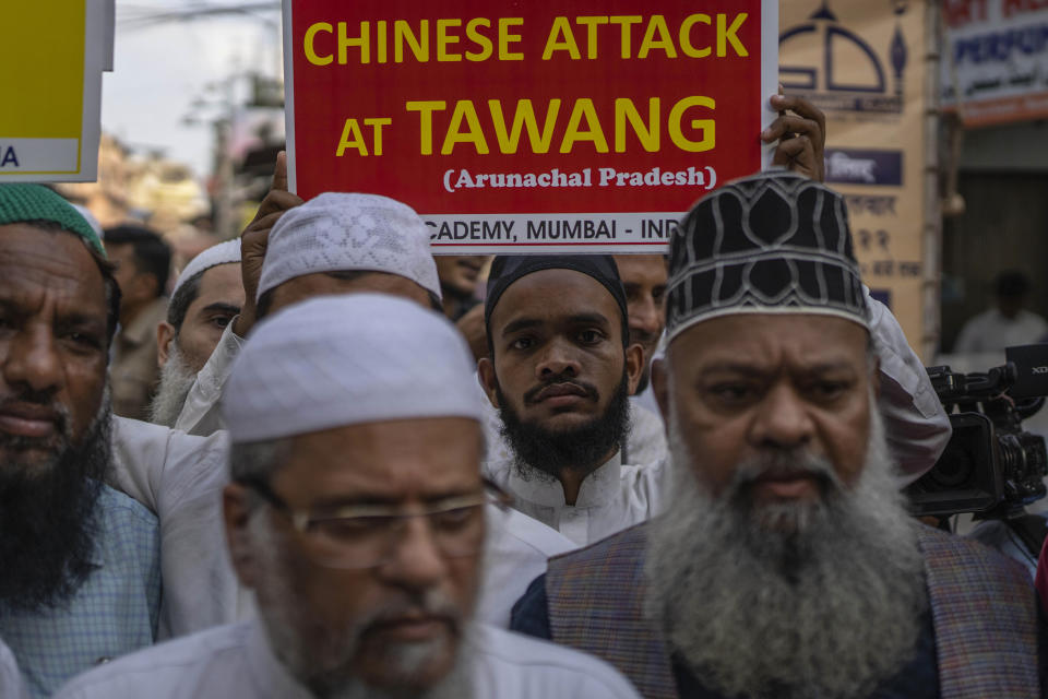 Indians hold placards during a protest against China in Mumbai, India, Tuesday, Dec. 13, 2022. Soldiers from India and China clashed last week along their disputed border, India's defense minister said Tuesday, in the latest violence along the contested frontier since June 2020, when troops from both countries engaged in a deadly brawl. (AP Photo/Rafiq Maqbool)