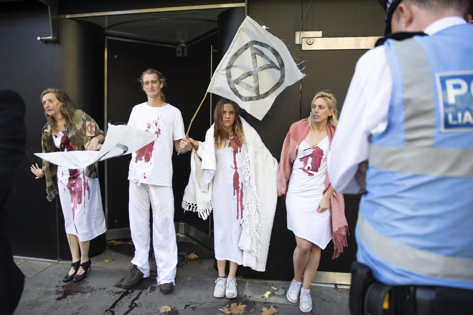 Extinction Rebellion protesters at the official opening of London Fashion Week in London, Friday Sept. 13, 2019. The group said five of its activists covered themselves in fake blood and staged a “die-in” to protest fashion’s contribution to the “climate and ecological crisis.” (Aaron Chown/PA via AP)