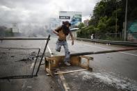 <p>A demonstrator jumps over a barricade during a national sit-in against President Nicolas Maduro, in Caracas, Venezuela, Monday, May 15, 2017. (AP Photo/Ariana Cubillos) </p>