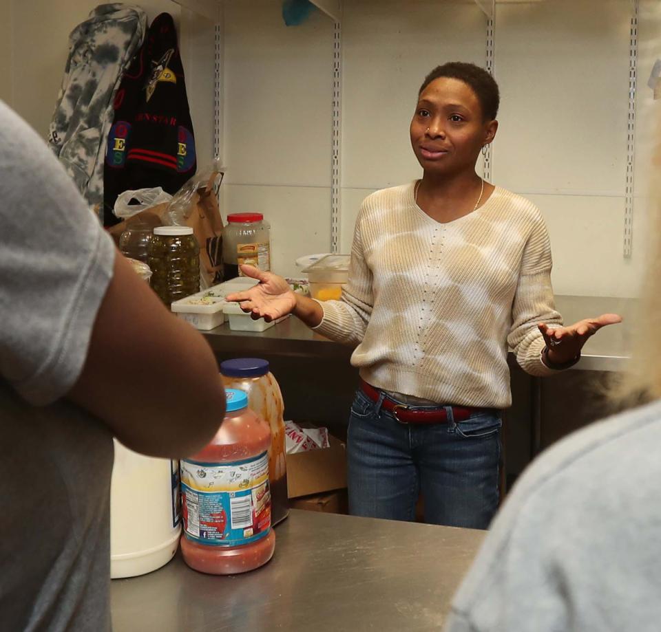 Chef Jen Tidwell talks to students during on-site restaurant training in the kitchen at NoHi as part of the Jump On Board for Success (JOBS) program’s culinary program in Akron.