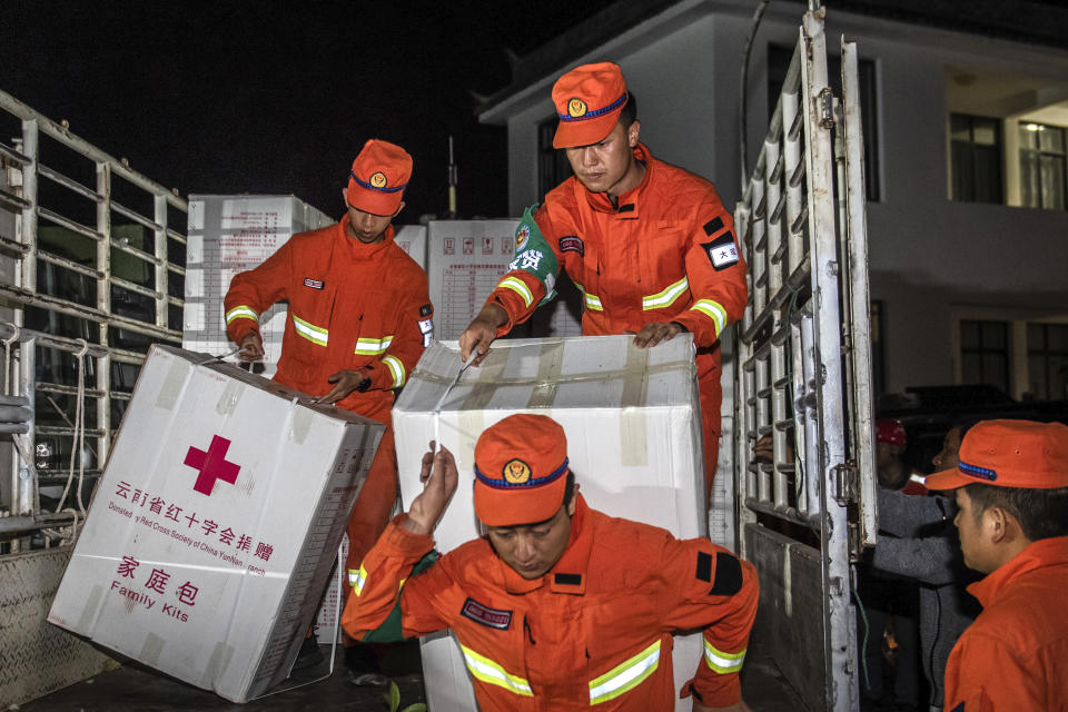 In this photo released by China's Xinhua News Agency, rescue personnel carry supplies after an earthquake in Yangbi Yi Autonomous County in southwestern China's Yunnan Province, early Saturday, May 22, 2021. A pair of strong earthquakes struck two provinces in China overnight on Saturday. (Hu Chao/Xinhua via AP)