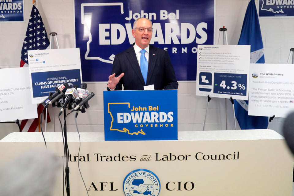 Louisiana Gov. John Bel Edwards, a Democrat, talks with reporters during a campaign stop in Shreveport, La., on Nov. 14.