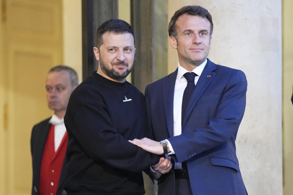FILE - French President Emmanuel Macron, right, welcomes Ukrainian President Volodymyr Zelenskyy at the Elysee palace in Paris, May 14, 2023. The symbolism will be palpable when leaders of the world’s rich democracies sit down in Hiroshima later this week. The Japanese city's name evokes the tragedy of war, and the leaders will tackle a host of challenges including Russia’s invasion of Ukraine and rising tensions in Asia. ( (AP Photo/Michel Euler, File)