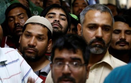 Asian workers gather as they speak to Reuters' journalists at their accommodation in Qadisiya labour camp, Saudi Arabia August 17, 2016. Picture taken August 17, 2016. REUTERS/Faisal Al Nasser