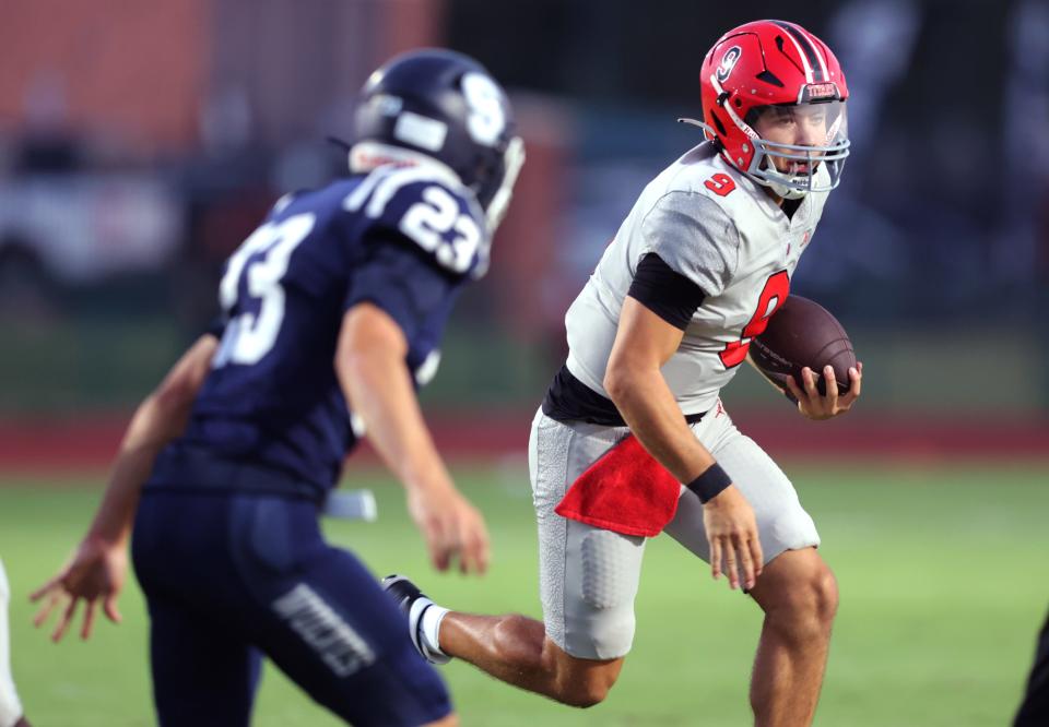 Carl Albert's Kevin Sperry rushes as Shawnee's Lance Williams defends during the high school football game between Shawnee and Carl Albert at Crain Family Stadium on the Oklahoma Baptist University campus in Shawnee, Okla., Thursday, Sept. 28, 2023.