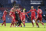 Liverpool's goalkeeper Alisson celebrates with teammates after scoring his side's second goal during the English Premier League soccer match between West Bromwich Albion and Liverpool at the Hawthorns stadium in West Bromwich, England, Sunday, May 16, 2021. (Laurence Griffiths/Pool via AP)