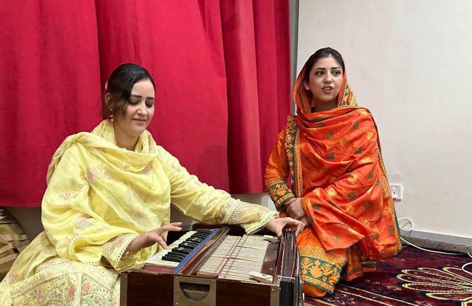 Afghan refugee sisters Khushi Mehtab, left and Asma Ayar, 28, practice their music in the one-room apartment they share with their younger brother in Islamabad, Pakistan, during a May 2023 interview with CBS News. / Credit: CBS News