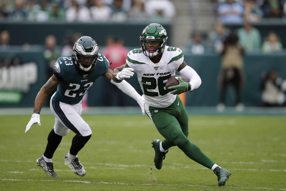 File-This Oct. 6, 2019, file photo shows New York Jets' Le'Veon Bell, right, rushing past Philadelphia Eagles' Rodney McLeod during the first half of an NFL football game in Philadelphia. The New York Jets have surprisingly released Bell, ending a disappointing tenure after less than two full seasons. The team issued a statement from general manager Joe Douglas on Tuesday, Oct. 13, 2020, in which he says the Jets made the move after having several conversations with Bell and his agent during the last few days and exploring trade options. (AP Photo/Matt Rourke, File)