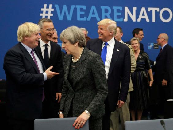 President Donald Trump jokes with then-foreign secretary Boris Johnson as Theresa May walks past during a 2017 Nato (AP)