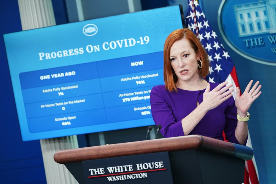 White House press secretary Jen Psaki gestures while standing at a podium.