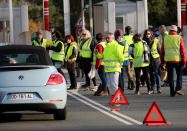 Demonstrators wearing yellow vests protest at the toll gates of a motorway, in Biarritz, southwestern France, Monday, Dec. 10, 2018. French President Emmanuel Macron will be speaking to his nation at last Monday, after increasingly violent, radicalized protests against his leadership have shaken the country and scarred its beloved capital. His long silence has aggravated that anger and many protesters are hoping only to hear one thing from Macron: “I quit.” (AP Photo/Bob Edme)
