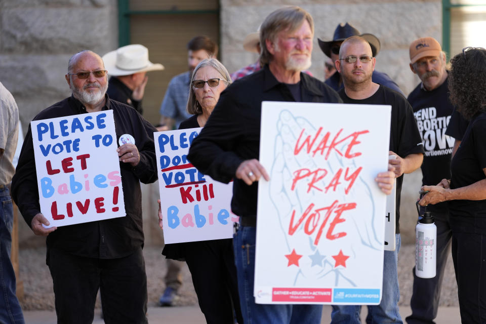 Anti-abortion supporters stand outside at the Capitol, Wednesday, May 1, 2024, in Phoenix. Democrats secured enough votes in the Arizona Senate to repeal a Civil War-era ban on abortions that the state's highest court recently allowed to take effect. (AP Photo/Matt York)