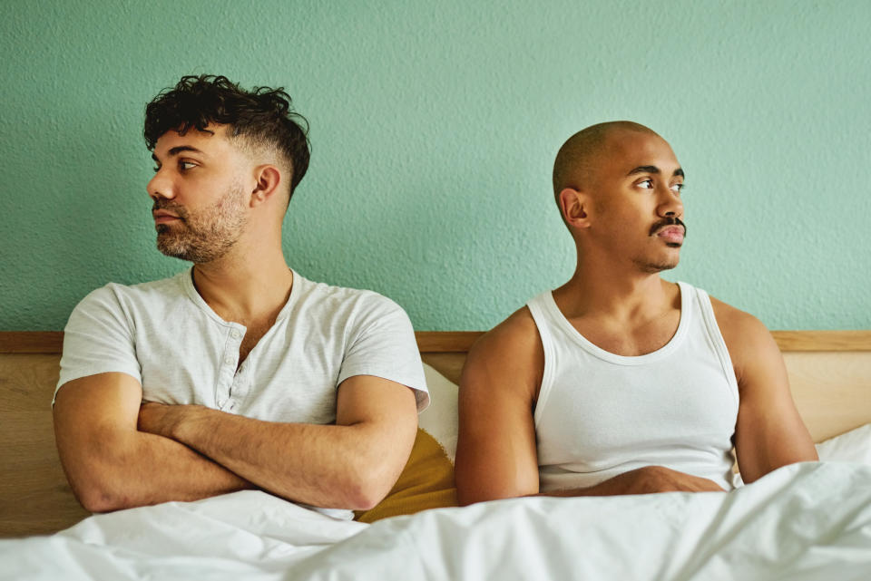 A couple in bed looking away from one another