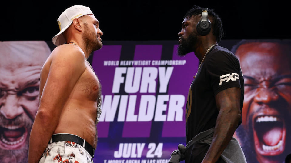 Tyson Fury, left, and Deontay Wilder in Los Angeles on June 15, 2021. / Credit: Mikey Williams/Top Rank Inc/ Getty