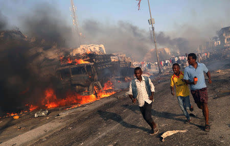 Civilians evacuate from the scene of an explosion in KM4 street in the Hodan district of Mogadishu, Somalia October 14, 2017. REUTERS/Feisal Omar