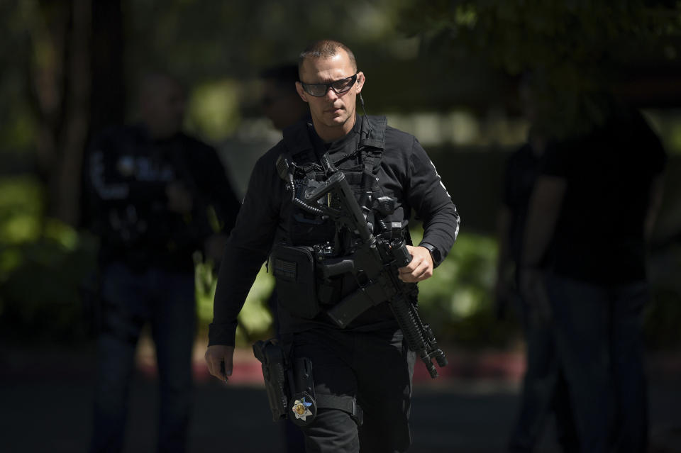 Police approach the apartment complex believed to be associated with a car crash suspect in Sunnyvale, Calif., on Wednesday, April 24, 2019. Investigators are working to determine the cause of a crash in Northern California that injured several pedestrians on Tuesday evening. Authorities say the driver of the car was taken into custody after he appeared to deliberately plow into the group. (AP Photo/Cody Glenn)