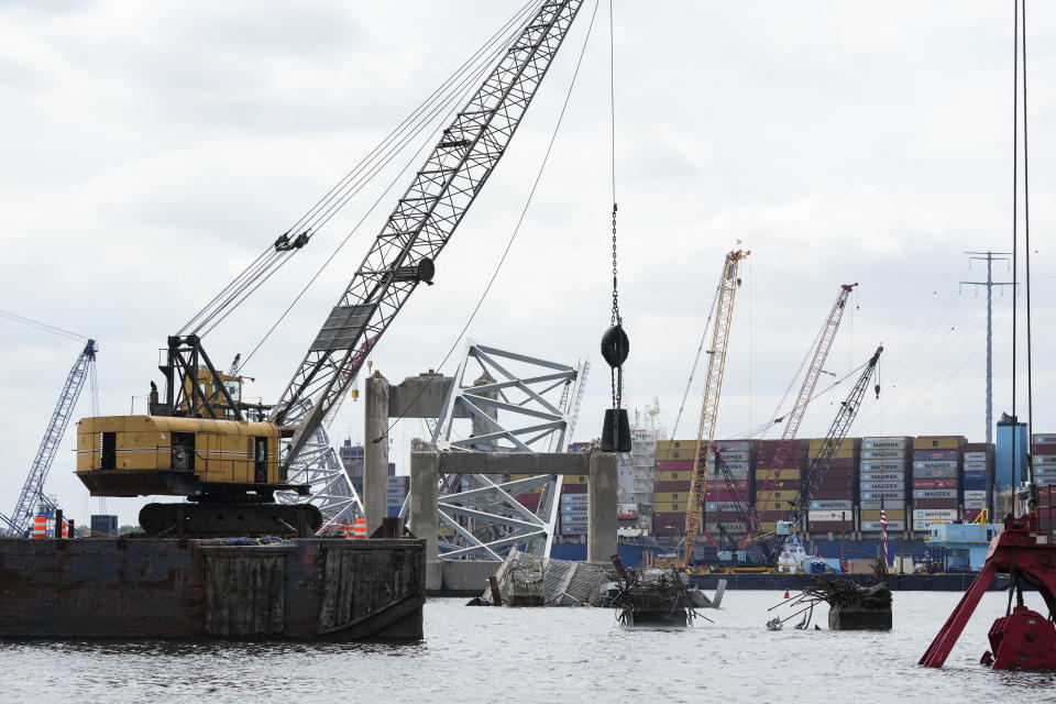 Workers remove wreckage of the collapsed Francis Scott Key Bridge, Thursday, April 25, 2024, in Baltimore. (AP Photo/Matt Rourke)