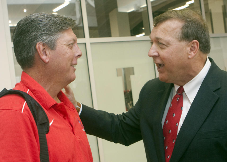 In this photo provided by Stony Brook University, school President Samuel L. Stanley, Jr., right, talks to men’s baseball head coach Matt Senk prior to the baseball teams departure for Omaha Nebraska to compete in the College World Series, Wednesday, June 13, 2012 at Stony brook University in Stony Brook, N.Y. (AP Photo/Stony Brook University, John Griffin)