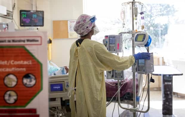 An ICU nurse tends to a patient at Scarborough Health Network’s Centenary Hospital in northeast Toronto earlier this month. (Evan Mitsui/CBC - image credit)