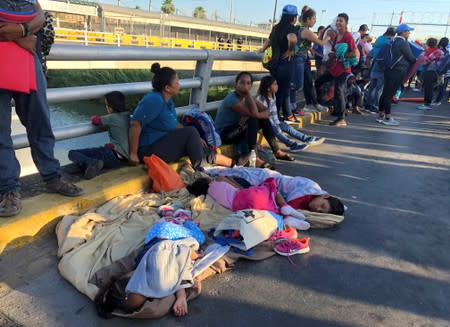 Migrants, returned to Mexico to await their U.S. asylum hearing as they block the Puerta Mexico international border crossing bridge to demand quickness in their asylum process in Matamoros