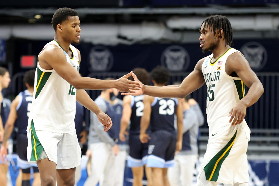 INDIANAPOLIS, INDIANA - MARCH 27: Jared Butler #12 and Davion Mitchell #45 of the Baylor Bears react in the second half of their Sweet Sixteen game against the Villanova Wildcats in the 2021 NCAA Men's Basketball Tournament at Hinkle Fieldhouse on March 27, 2021 in Indianapolis, Indiana. (Photo by Andy Lyons/Getty Images)