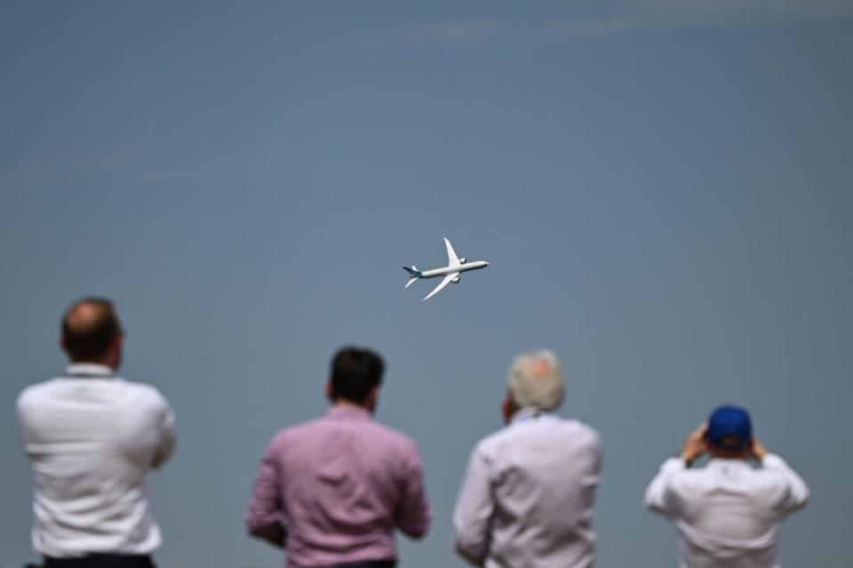 People watch a Boeing aeroplane at Farnborough Air Show on Tuesday where the government launched its new aviation strategy (AFP via Getty)