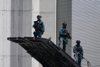 Security stands guard as they wait for President Joe Biden to deplane from Air Force One at Madrid's Torrejon Airport, Tuesday, June 28, 2022. Biden is in Spain to attend the North Atlantic Treaty Organization summit. (AP Photo/Susan Walsh)