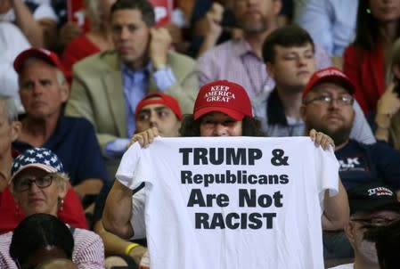 FILE PHOTO: A supporter reacts by showing a t-shirt as U.S. President Donald Trump speaks during a campaign rally in Cincinnati