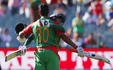 Bangladesh batsman Mohammad Mahmudullah (L) is hugged by team mate Mushfiqur Rahim after scoring his nation's first ever century in a world cup during their Cricket World Cup match against England in Adelaide, March 9, 2015. REUTERS/David Gray