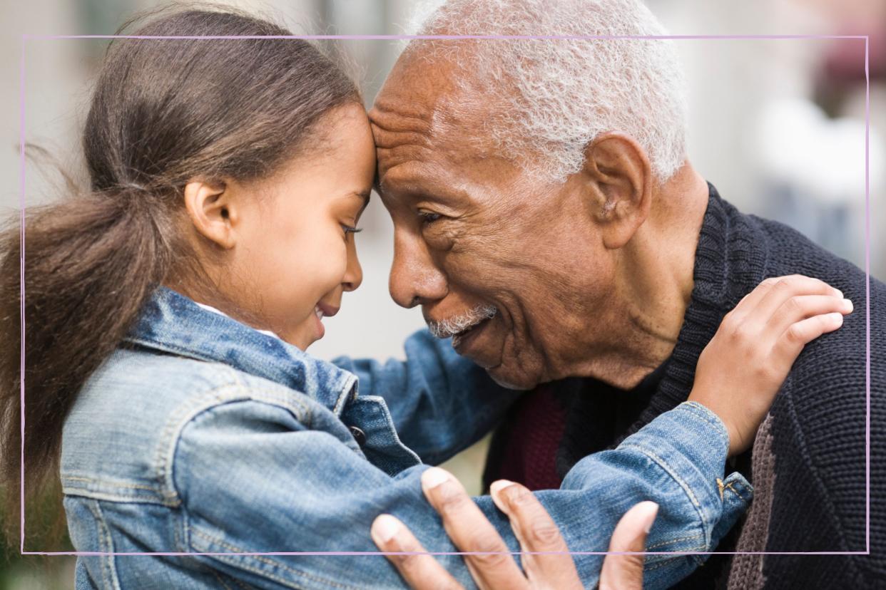  Grandfather hugging granddaughter . 