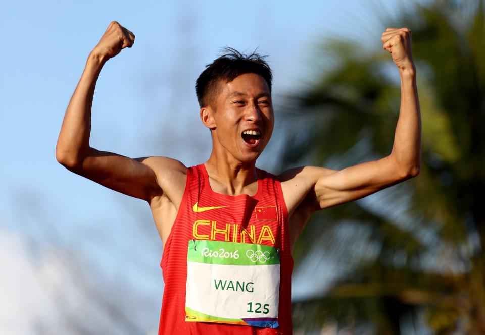 <p>Zhen Wang of China celebrates winning gold in the Men’s 20km Race Walk on Day 7 of the Rio 2016 Olympic Games at Pontal on August 12, 2016 in Rio de Janeiro, Brazil. (Getty) </p>