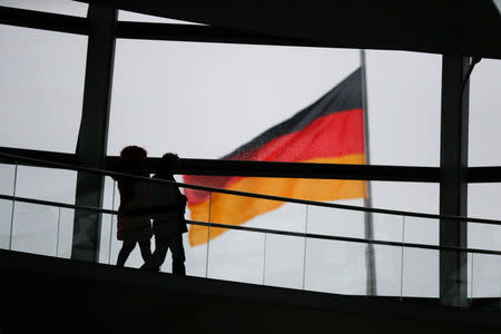 Visitors walk inside the glass dome of the Reichstag building, the seat of the German lower house of parliament Bundestag in Berlin, Germany, January 12, 2018. REUTERS/Hannibal Hanschke