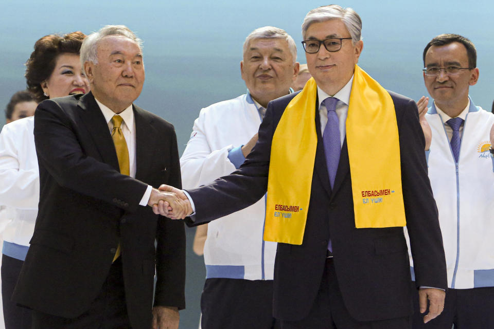 Kazakhstan's acting President Kassym-Jomart Tokayev, right, and Former Kazakh President Nursultan Nazarbayev shake hands in front of supporters in Nur-Sultan, Kazakhstan, June 7, 2019. / Credit: Alexei Filippov/AP