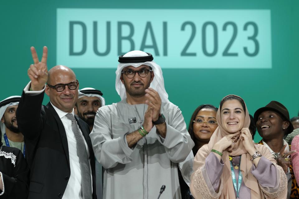 United Nations Climate Chief Simon Stiell, from left, COP28 President Sultan al-Jaber and Hana Al-Hashimi, chief COP28 negotiator for the United Arab Emirates, pose at the end of the COP28 U.N. Climate Summit, Wednesday, Dec. 13, 2023, in Dubai, United Arab Emirates. (AP Photo/Peter Dejong)