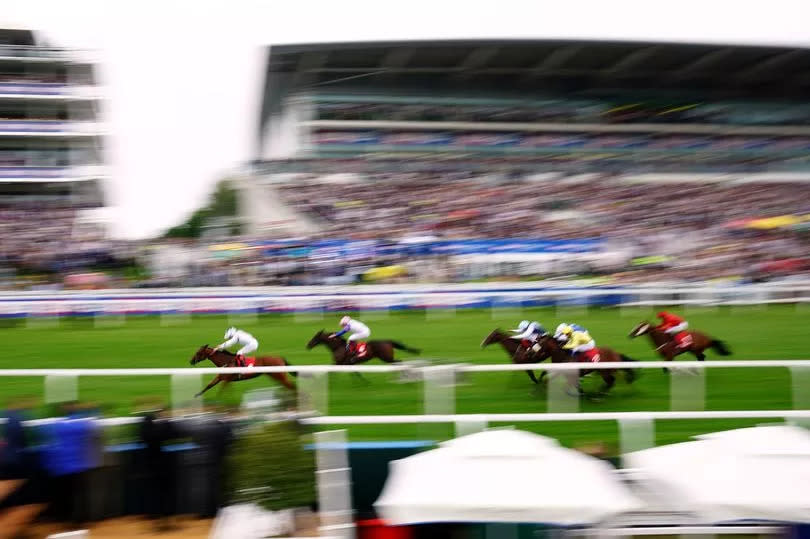 Teej A, ridden by jockey Clifford Lee (front, left), on the way to winning the Betfred British EBF Woodcote Stakes on day one of the Betfred Derby Festival at Epsom Downs Racecourse on Friday, May 31 2024