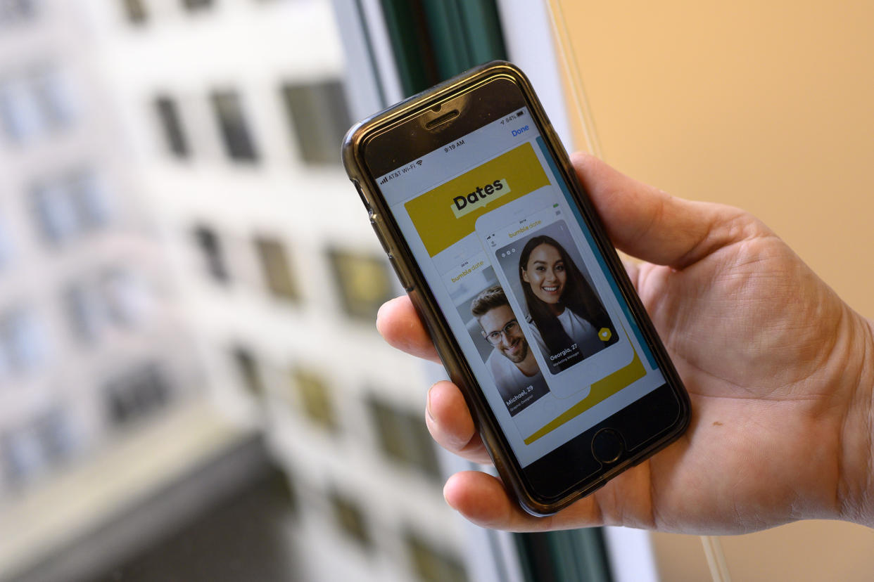 An AFP journalist holds his phone showing the dating application Bumble on February 26, 2020 in Washington,DC. - Days ahead of the Iowa Caucuses vote, Rhiannon Payne was on the Bumble dating app -- not to find a partner but to press her case for her candidate, Elizabeth Warren. 
Payne, a 28-year-old digital communications consultant, flew from San Francisco with a friend to volunteer for the Warren campaign and the two women came up with the idea while sitting in a hotel room. 