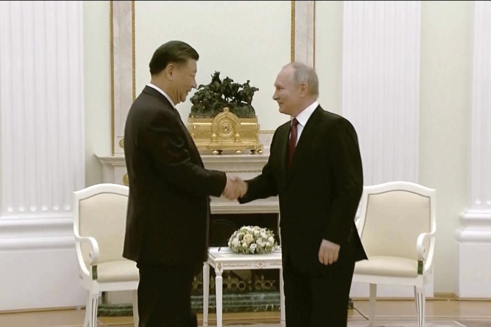 In this grab taken from video, China's President Xi Jinping, left, and Russian President Vladimir Putin shake hands during their meeting in Moscow, Russia, Monday, March 20, 2023. (Russian Pool via AP)