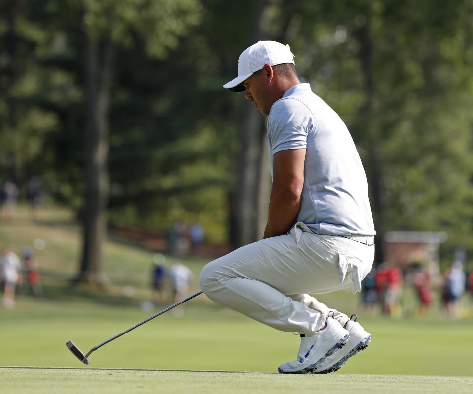 Brooks Koepka reacts to a missed putt on the 12th hole during the third round of the PGA Championship golf tournament at Bellerive Country Club, Saturday, Aug. 11, 2018, in St. Louis. (AP Photo/Jeff Roberson)