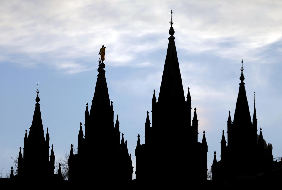 FILE- In this Jan. 3, 2018, file photo, the angel Moroni statue, silhouetted against the sky, sits atop the Salt Lake Temple of The Church of Jesus Christ of Latter-day Saints, at Temple Square, in Salt Lake City. The Church of Jesus Christ of Latter-day Saints has postponed a key meeting of top global leaders scheduled for April 1-2 because of the spread of the coronavirus around the world. The faith is also discouraging members from traveling from outside the United States for a twice-yearly conference set for the weekend of April 4-5 in Salt Lake City, the religion said in a news release Thursday, Feb. 27, 2020. (AP Photo/Rick Bowmer, File)