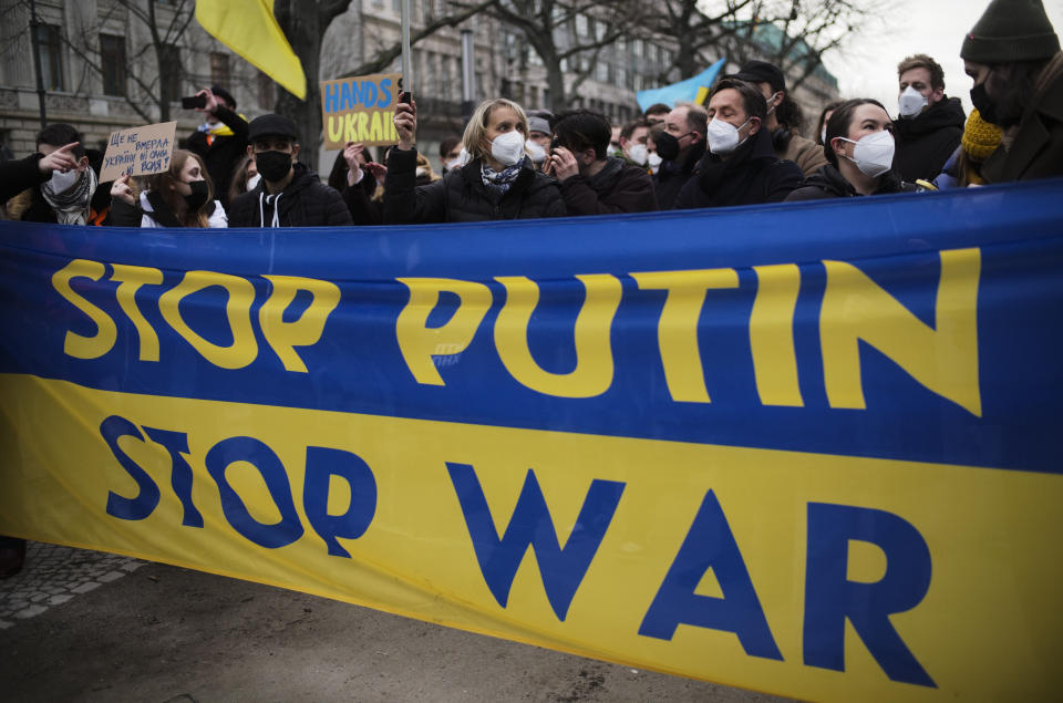 Demonstrators march along the street near the Russian embassy to protest against the escalation of the tension between Russia and Ukraine in Berlin, Germany, Tuesday, Feb. 22, 2022. Russian President Vladimir Putin has asked the country’s parliament for permission to use military force outside the country. That could presage a broader attack on Ukraine after the U.S. said an invasion was already underway there. (AP Photo/Markus Schreiber)