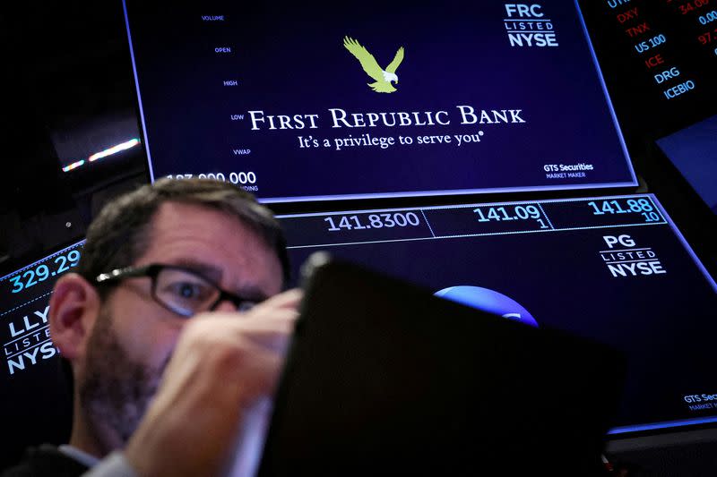 FILE PHOTO: Traders work on the floor of the NYSE in New York