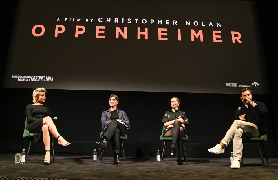 The four panelists sitting onstage