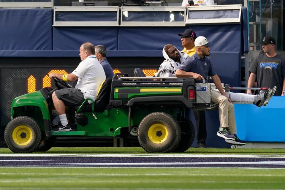 Seattle Seahawks wide receiver DK Metcalf (14) leaves the field with an injury during the first half of an NFL football game against the Los Angeles Chargers Sunday, Oct. 23, 2022, in Inglewood, Calif. (AP Photo/Mark J. Terrill)