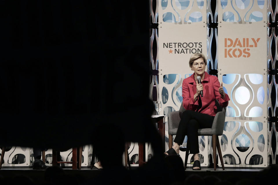 Democratic presidential candidate Elizabeth Warren addresses shouting people who stood up with a large banner while Warren was speaking during a forum sponsored by Netroots, Saturday, July 13, 2019 at the Pennsylvania Convention Center in Philadelphia. (Elizabeth Robertson/The Philadelphia Inquirer via AP)